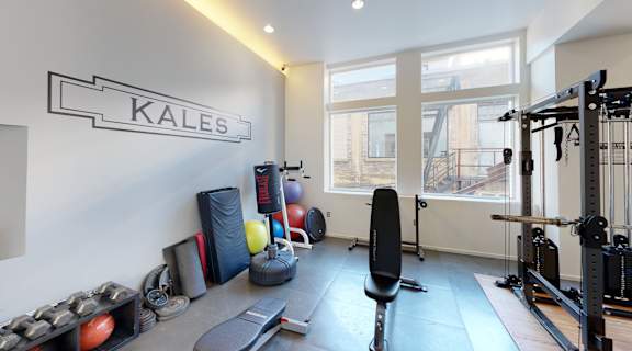 a home gym with weights and cardio equipment