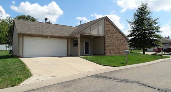 the front of a house with a driveway and a garage door