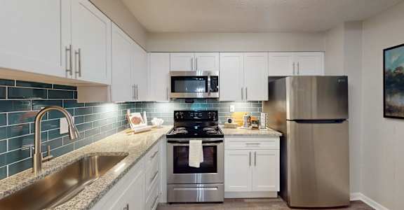 A kitchen with a stainless steel refrigerator, stove, and oven. at Vinings RiverVue, Atlanta, GA