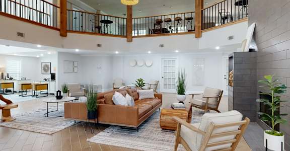 A living room with a brown sofa and a fireplace. at Vinings RiverVue, Atlanta, GA, 30339