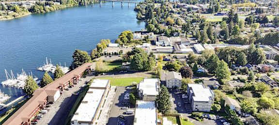 A large body of water with a bridge in the background and a building in the foreground.