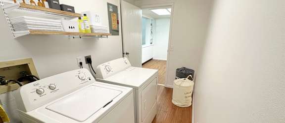A small laundry room with a washer and dryer.