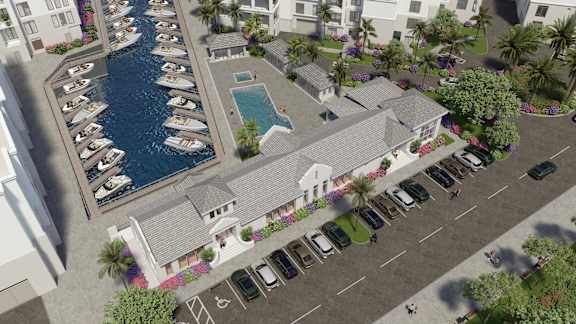 A marina with boats docked in the water and a building with a pool in front.