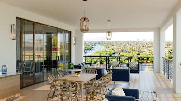 A modern dining area with a view of a river and trees.