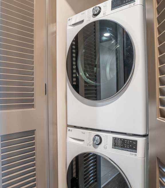 A modern laundry room with a washer and dryer.