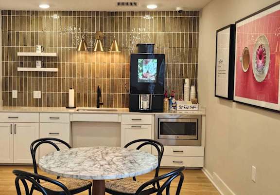 a small kitchen with a table and chairs and a tv