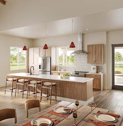 A modern kitchen with a dining table set for a meal.