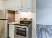 Thumbnail 2 of 8 - a kitchen with stainless steel appliances and white cabinets