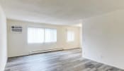 Thumbnail 5 of 8 - the living room and dining room of an empty home with white walls and wood floors