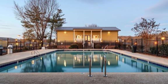 a swimming pool with a house in the background