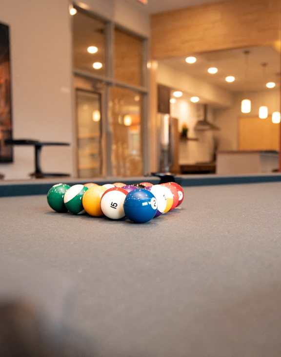 a billiards table in a room with pool balls