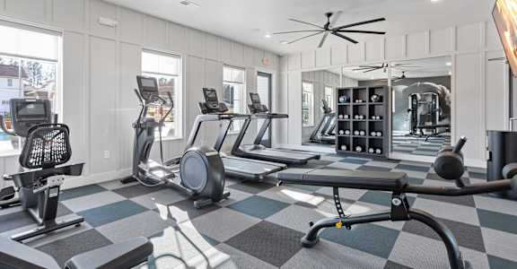 a large modern fitness center with cardio and strength training equipment at Sanctuary at Indian Creek