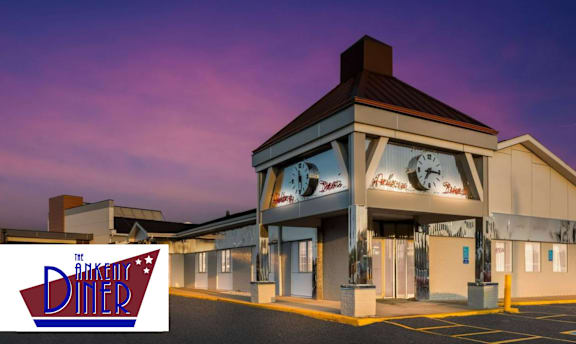 The exterior of The Diner restaurant with a logo in the foreground.