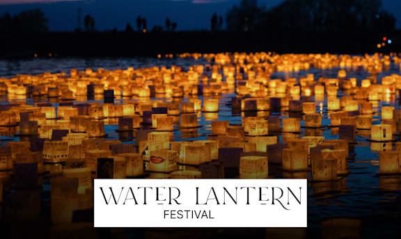 A festival with many lanterns floating on water.
