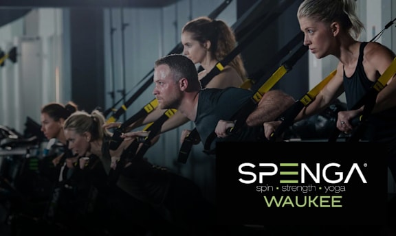 A group of people exercising in a Spenga Waukee gym.