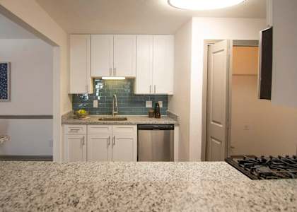 A kitchen with white cabinets and a granite countertop. at Paces Ridge at Vinings, Georgia, 30339
