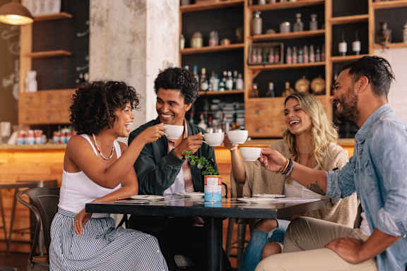 Four people are sitting around a table in a restaurant.