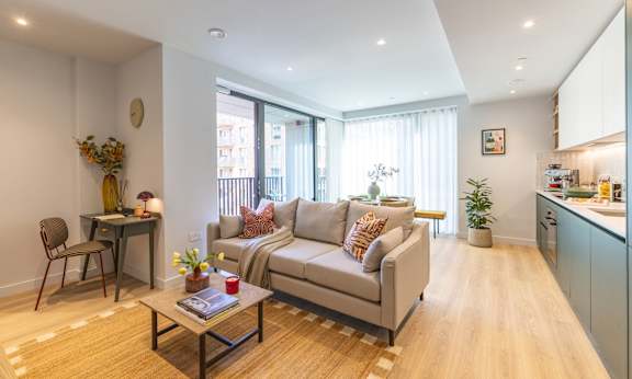A living room with a grey couch and a coffee table.