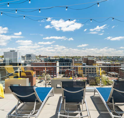 A rooftop patio with chairs and string lights | Grand Rapids MI Apartments