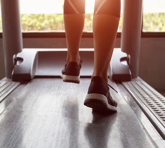 a woman is running on a treadmill