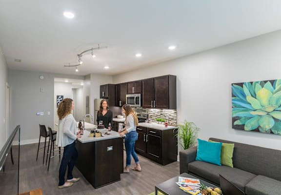Three women are standing in a modern kitchen | Grand Rapids MI Apartments