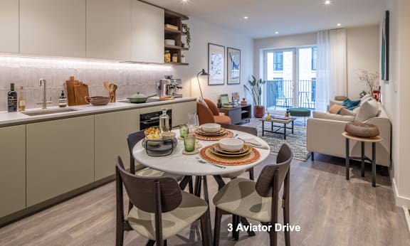 A well-lit kitchen and dining area with a table set for a meal.