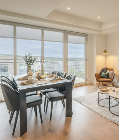 A modern living room with a dining table and a couch.