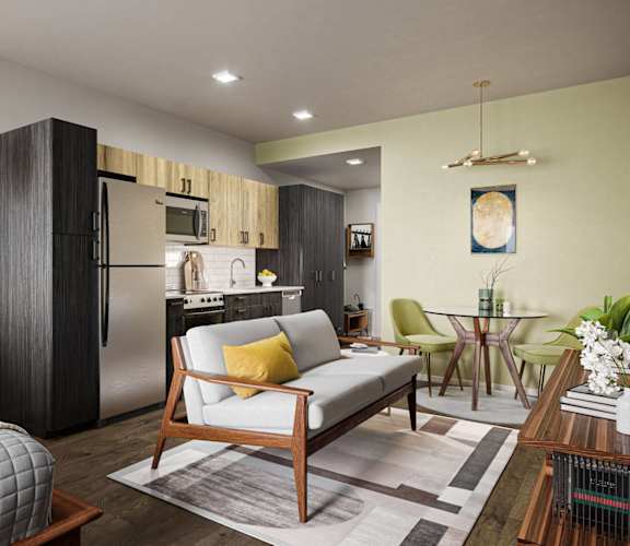a studio apartment with a bed and a kitchen