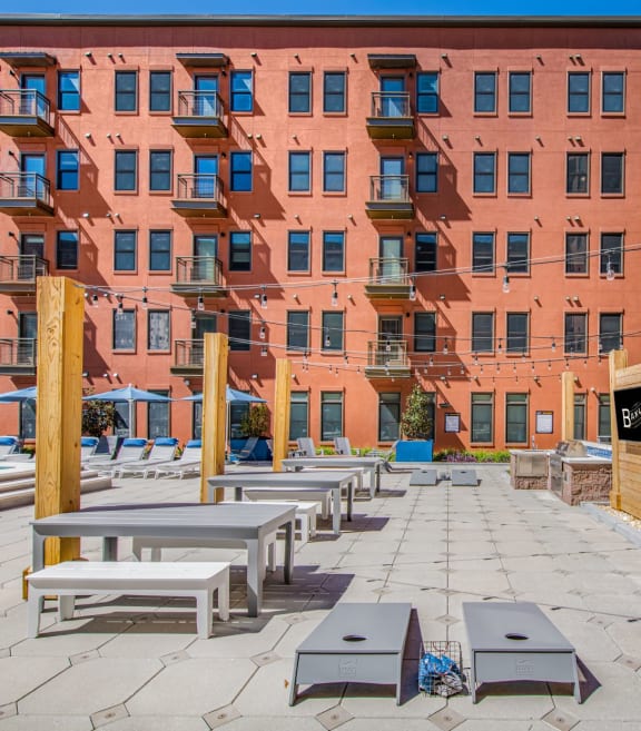 an outdoor patio with tables and benches at The Baxly, Savannah, GA