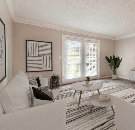 A living room with a white couch, a coffee table, and a flat screen TV mounted on the wall.