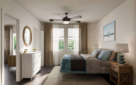 A bedroom with a bed, dresser, and window with curtains.