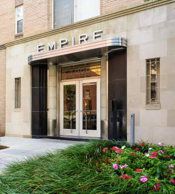 building exterior with grass on each side of walkway at Empire Apartments in Washington, DC