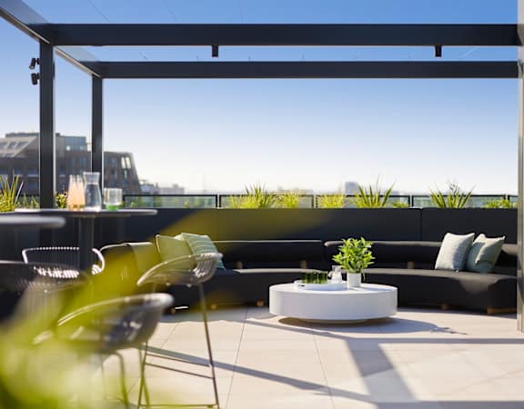 a roof terrace with a table and chairs