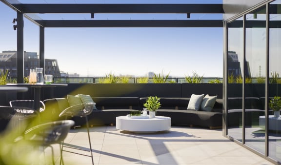 a roof terrace with a table and chairs