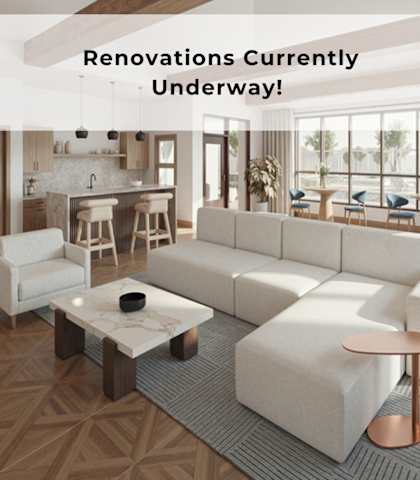 A modern living room with a large white sofa and a coffee table.