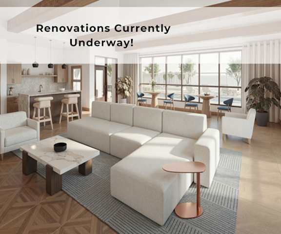 A modern living room with a large white sofa and a coffee table.
