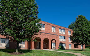 A red brick building with arched doorways and windows.