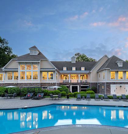 A large house with a pool in front.
