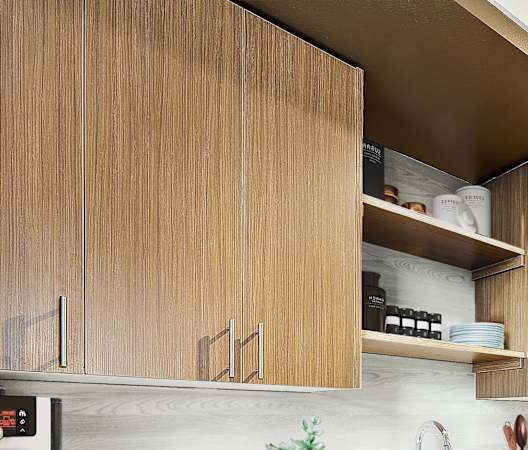 a kitchen with wooden cabinets and stainless steel appliances at The Hayes on Stone Way, Seattle, WA, 98103