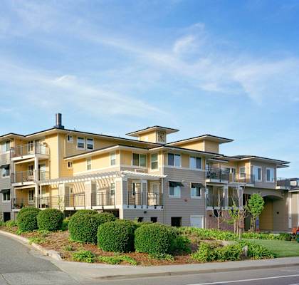 A large apartment complex with a street in front.