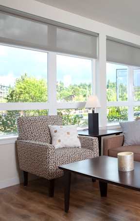 A living room with a couch, chair, and table.