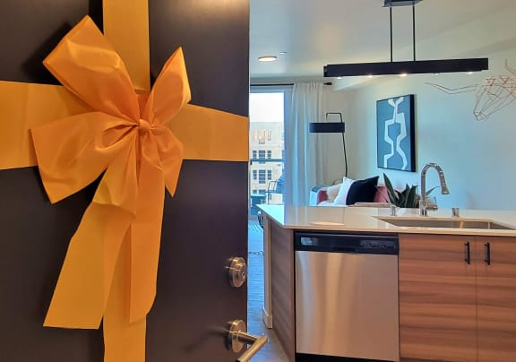 a kitchen with an orange ribbon on the door