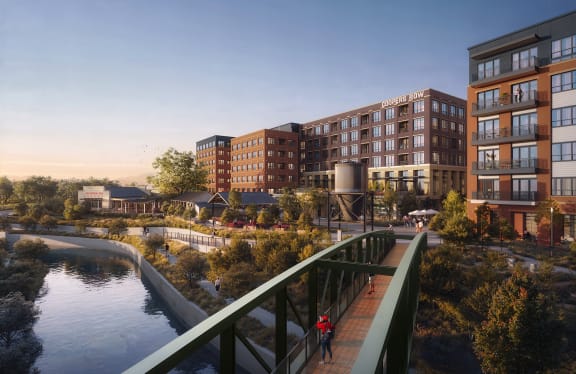 a bridge over a river with buildings in the background