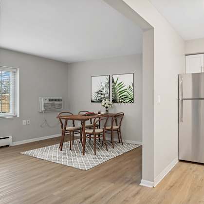 A kitchen with a table and chairs in the middle of the room.