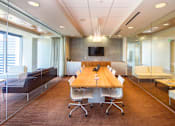 Thumbnail 11 of 18 - A conference room with a long table and chairs.