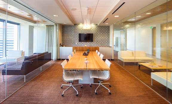 A conference room with a long table and chairs.
