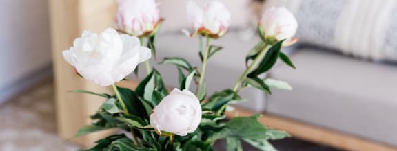 a blue vase filled with white flowers on a table