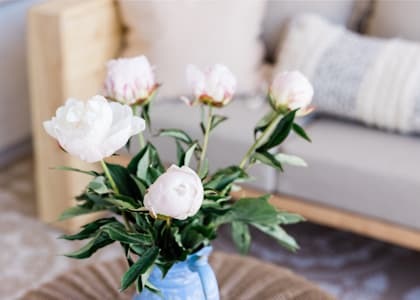 A bouquet of white flowers in a blue vase.