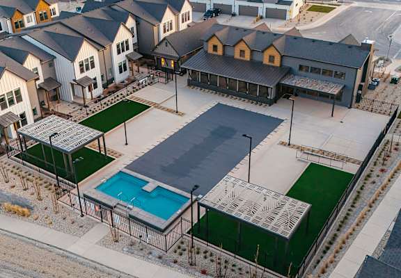 A large building with a pool in front of it.