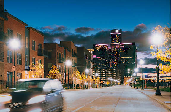 A black and white image of a city street with buildings on either side.